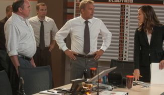 Kevin Costner, center, portrays the general manager of the Cleveland Browns and Jennifer Garner, right, is the team&#39;s lawyer in a scene in &quot;Draft Day.&quot; (credit)