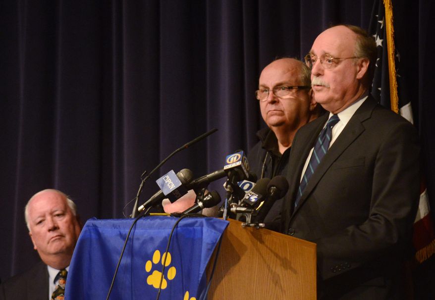 Westmoreland County DA John W. Peck, right, takes questions during a press conference while Murrysville Mayor Robert J. Brooks, left, and Westmoreland County Public Safety PIO Dan Stevens look on at Franklin Regional Middle School on Wednesday, April 9, 2014. Governor Tom Corbett paid a visit to Franklin Regional to address the stabbing incident occurring earlier in the day at Franklin Regional High School. (AP Photo/Tribune Review, Evan Sanders) PITTSBURGH OUT