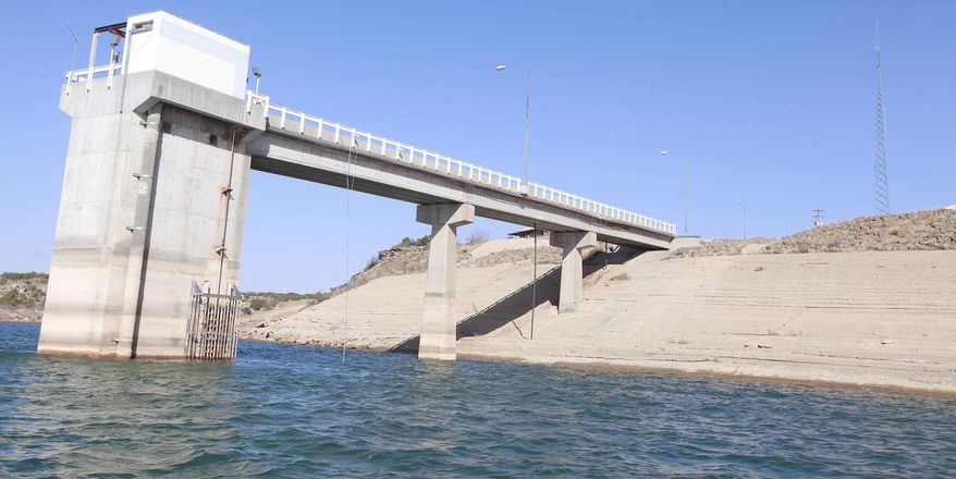 ADVANCE FOR RELEASE MONDAY, APRIL 14, 2014, AND THEREAFTER- This March 20, 2014, photo shows the John T. Montford Dam at Lake Alan Henry in Texas. The lake lost roughly 4 billion gallons of water to evaporation in 2011, thanks to a lingering drought and sweltering temperatures and still more water is simply missing, according to federal government data. (AP Photo/Lubbock Avalanche-Journal, Stephen Spillman)