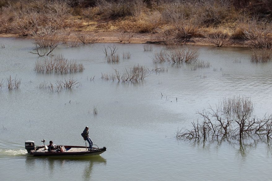 ADVANCE FOR RELEASE MONDAY, APRIL 14, 2014, AND THEREAFTER- In this March 18, 2014 photo, fishermen troll for their next catch at Lake Alan Henry in Texas. The lake lost roughly 4 billion gallons of water to evaporation in 2011, thanks to a lingering drought and sweltering temperatures and still more water is simply missing, according to federal government data. (AP Photo/Lubbock Avalanche-Journal, Stephen Spillman)
