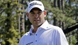 Bill Haas walks off the 18th green with his course notes after his first round of the Masters golf tournament Thursday, April 10, 2014, in Augusta, Ga. (AP Photo/David J. Phillip) 