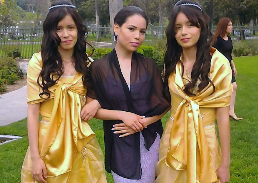 This 2013 photo provided by Miguel Serrato shows twin sisters Marisol Serrato, 17, left, and Marisa Serrato, right, with their sister-in-law Ivette Serrato during a wedding in Riverside, Caif. The twins were part of the group more than 40 high school students whose trip to visit a college turned tragic when a FedEx tractor-trailer veered across a grassy highway median and slammed into their bus in a wreck that left 10 people dead, authorities said. Marisa was one of the twins on the bus that crashed but is still unaccounted for. Marisol was on another bus that wasn't in the accident. (AP Photo/Courtesy Miguel Serrato)