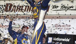Chase Elliott celebrates in Victory lane after winning a NASCAR Nationwide series auto race at Darlington Speedway in Darlington, S.C., Friday, April 11, 2014. (AP Photo/Chuck Burton)