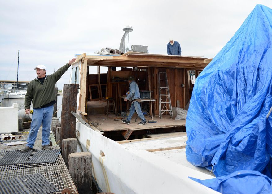 CORRECTS SPELLING - Bert Ducote talks about performing cleanup work with his boat during the Deepwater Horizon oil spill. The boat is being rebuilt at the Lake Catherine Marina in New Orleans, Friday, March 7, 2014. Ducote has had dozens of boils pop up on his skin since helping to work the oil spill cleanup. (AP Photo/Andrea Mabry)