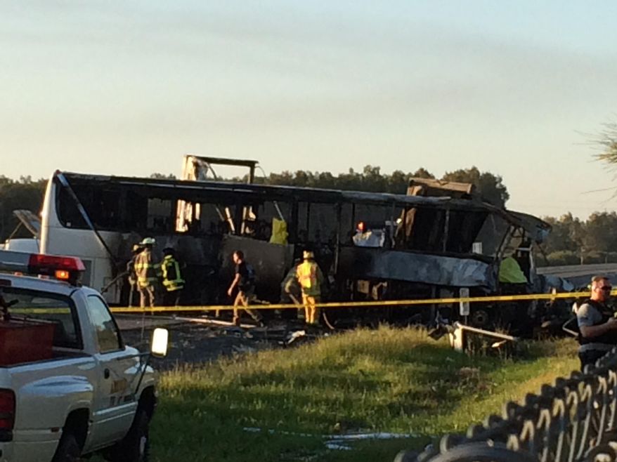 In this photo provided by Andrew Hutchens, authorities work the scene where nine people were killed in a three-vehicle crash involving a bus carrying high school students on a visit to a college, Thursday, April 10, 2014, near Orland, Calif. Authorities said it is not yet clear what caused the crash but that it involved a tour bus, a FedEx truck and a Nissan Altima. (AP Photo/Andrew Hutchens)