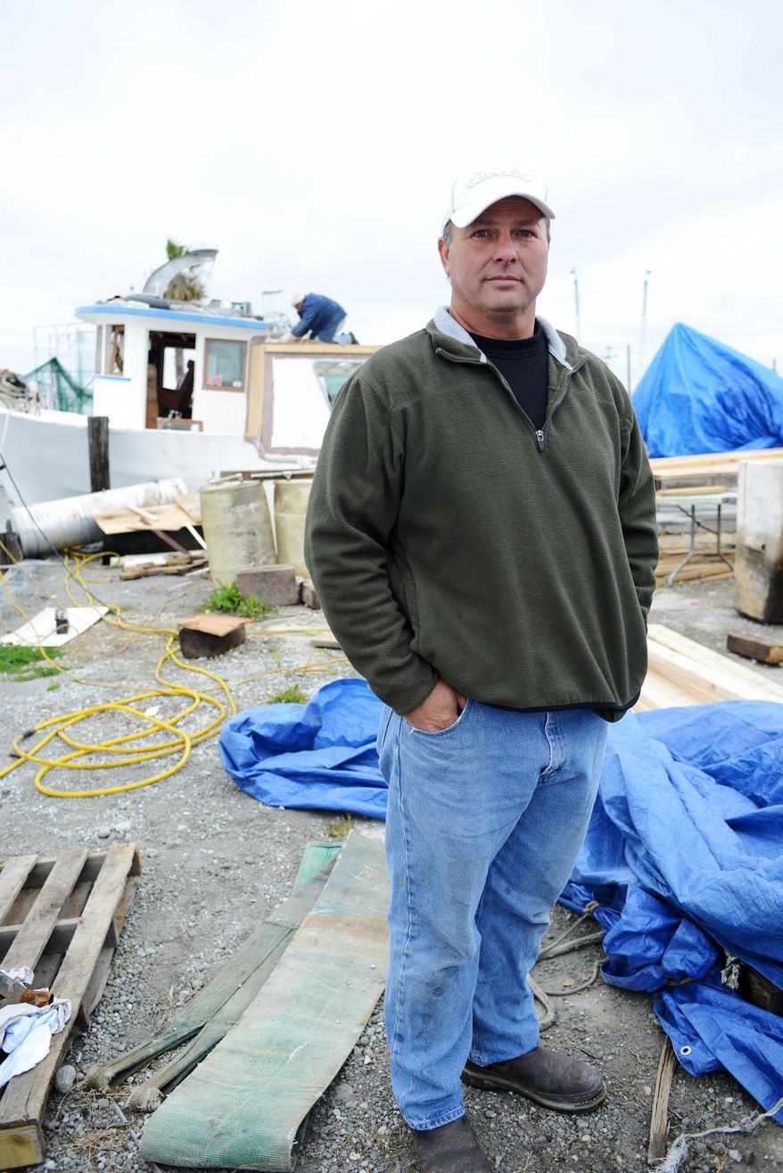 CORRECTS SPELLING - Bert Ducote poses for a picture at the Lake Catherine Marina, where his boat is being rebuilt, in New Orleans, Friday, March 7, 2014. Ducote has had dozens of boils appear on his skin, which he claims are the result of being in direct contact with crude oil while performing cleanup work during the Deepwater Horizon oil spill. (AP Photo/Andrea Mabry)