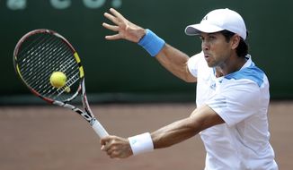Fernando Verdasco, of Spain, returns a shot to Donald Young in the first set of their quarterfinals match in the U.S. Men&#x27;s Clay Court Championship Friday, April 11, 2014, in Houston. (AP Photo/Pat Sullivan)