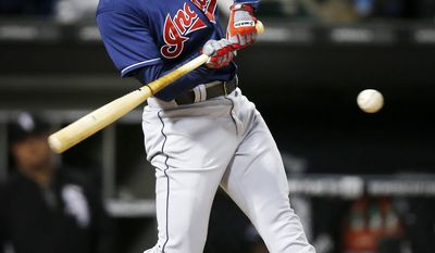 Cleveland Indians&#x27; Elliot Johnson hits a double against the Chicago White Sox during the fifth inning of a baseball game on Friday, April 11, 2014, in Chicago. (AP Photo/Andrew A. Nelles)