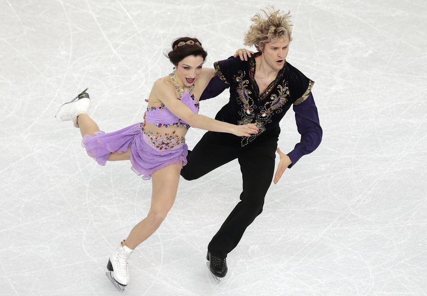 FILE - In this Feb. 17, 2014, file photo, Meryl Davis and Charlie White compete in the ice dance free dance figure skating finals at the Iceberg Skating Palace during the 2014 Winter Olympics in Sochi, Russia. After years of hard work and outstanding performances culminated in an Olympic gold medal Davis and White would seem to deserve down time. Instead, and by choice, the ice dance champions are busier than ever. (AP Photo/Ivan Sekretarev, File)