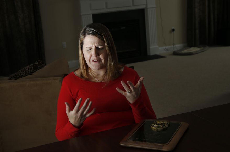 ADVANCE FOR USE SATURDAY, APRIL 12, 2014 AND THEREAFTER - In this March 14, 2014 photo, Nicole Lynch, sister of slain Massachusetts Institute of Technology police officer Sean Collier, speaks during an interview at her home in Dracut, Mass. Collier was allegedly killed by the two suspects in the Boston Marathon bombings on April 19, 2013. Lynch still mourns her brother and will be at the 2014 race with Team Collier Strong to raise money for a scholarship fund to put one person a year through law enforcement training. (AP Photo/Elise Amendola)
