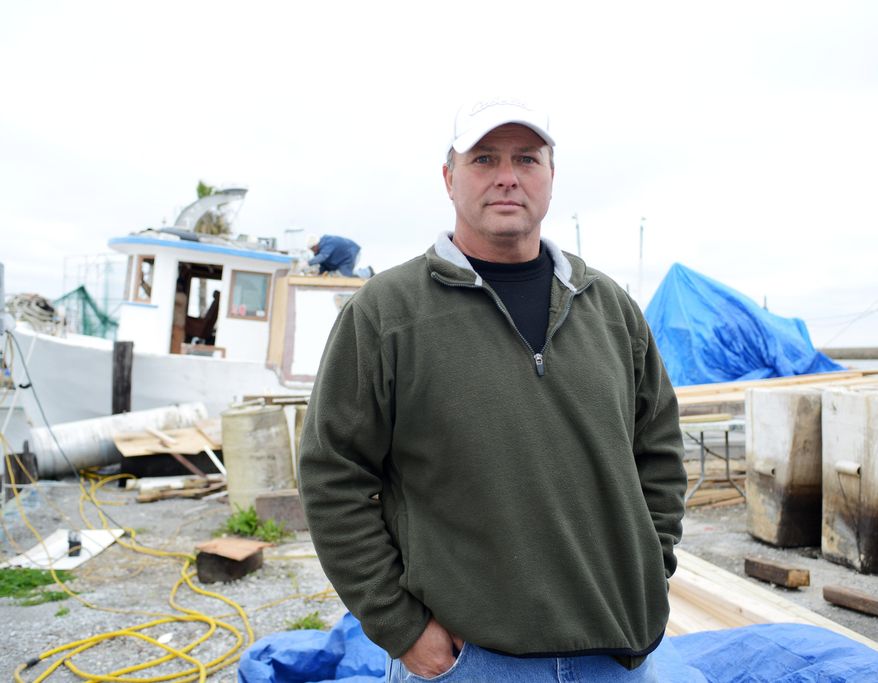CORRECTS SPELLING - Bert Ducote poses for a picture at the Lake Catherine Marina, where his boat is being rebuilt, in New Orleans, Friday, March 7, 2014. Ducote has had dozens of boils appear on his skin, which he claims are the result of being in direct contact with crude oil while performing cleanup work during the Deepwater Horizon oil spill. (AP Photo/Andrea Mabry)