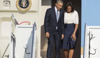 President Barack Obama and first lady Michelle Obama disembark from Air Force One as they arrive Andrews Air Force Base, Md., Thursday, April 10,  2014, from a trip in Texas.  (AP Photo/Manuel Balce Ceneta)