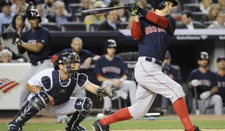 Boston Red Sox batter Grady Sizemore hits a three-run home run as New York Yankees catcher Francisco Cervelli, left, looks on during the sixth inning of a baseball game Friday, April 11, 2014, at Yankee Stadium in New York. (AP Photo/Bill Kostroun)