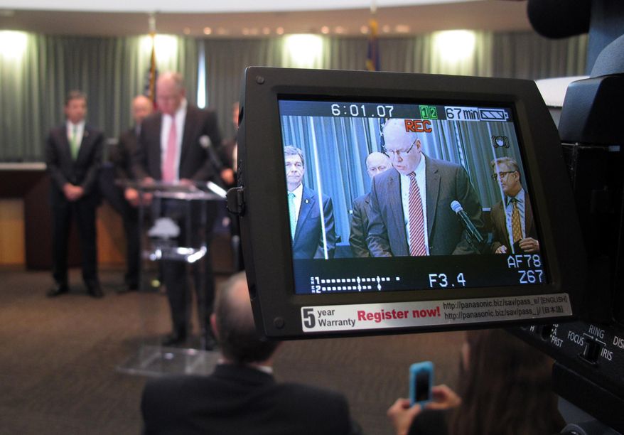 John Strong, FBI special agent in charge of North Carolina, is displayed on a camera monitor as he addresses the media during a news conference at the Wake Forest Town Hall on Thursday, April 10, 2014, in Wake Forest, N.C. Strong said the kidnapping of Frank Arthur Janssen was related to his daughter's prosecution of North Carolina prisoner Kelvin Melton, who is serving a life sentence for his 2012 conviction for being a habitual felon. Melton, 49, was also convicted of assault with a deadly weapon with intent to kill. (AP Photo/Allen G. Breed)