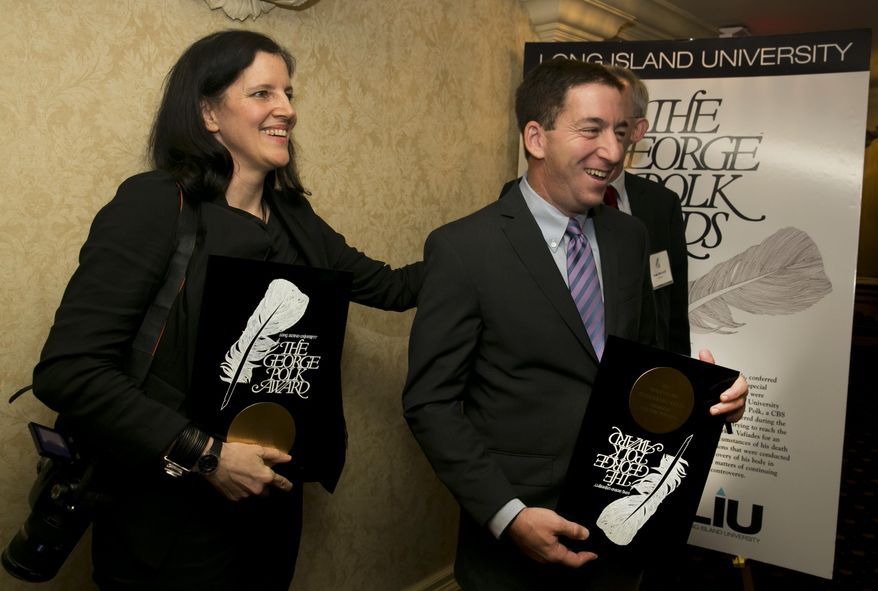 Laura Poitras and Glenn Greenwald, two reporters central to revealing the massive U.S. government surveillance effort, pose for photos after they received the George Polk Award for National Security Reporting, at New York's Roosevelt Hotel, Friday, April 11, 2014. They returned to the United States for the first time since the story broke to receive the journalism award. (AP Photo/Richard Drew)
