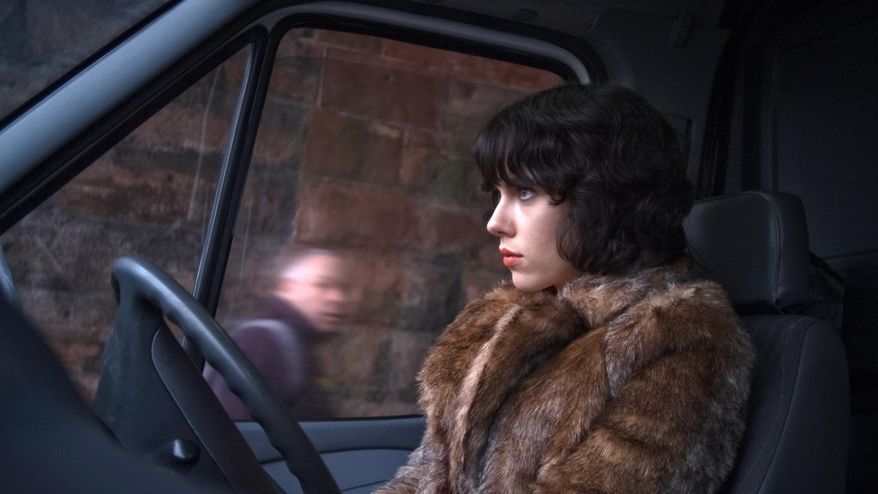 This image released by A24 Films shows Scarlett Johansson in a scene from "Under the Skin." Sandwiched between the swaggering spectacle of summer and the chest-thumping ambition of awards season, spring moviegoing is usually an afterthought, a limbo for films not bankable enough for July or sufficiently arty-seeming for Oscar. But this season, the movies are alive. (AP Photo/A24 Films)