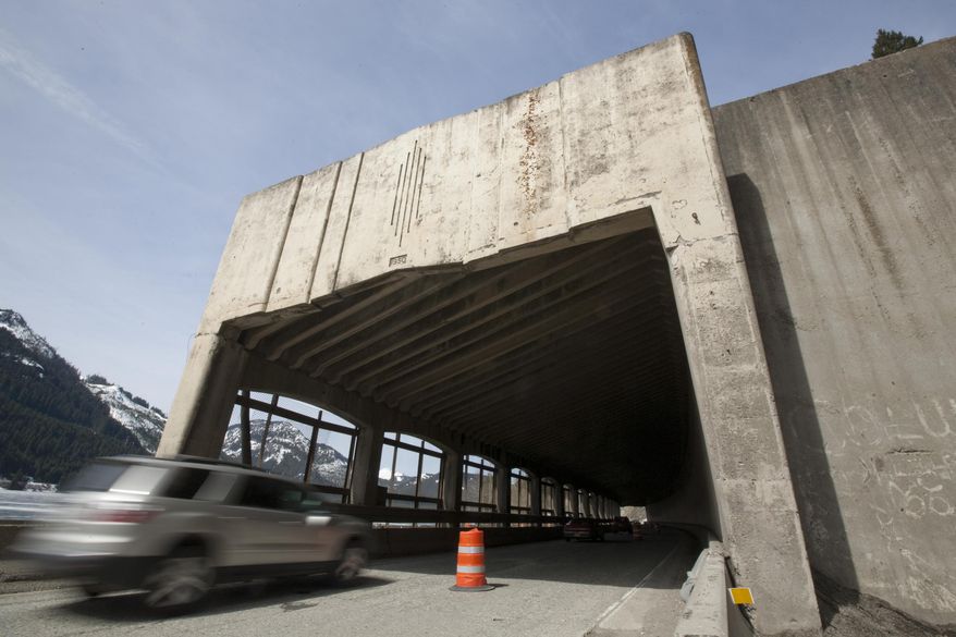 A car enters the snow shed on the westbound lanes of I-90 just east of Snoqualmie Pass April 10, 2014. The 64-year-old shed, built to protect the roadway from avalanches from adjacent slopes, will be torn down starting Sunday, April 13. It's being removed to permit widening of the interstate and construction of bridges under which avalanches will run. (AP Photo/Yakima Herald-Republic, Gordon King)