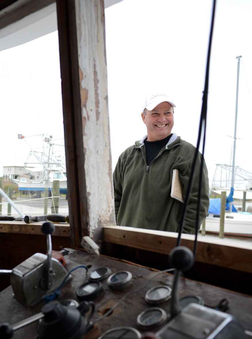CORRECTS SPELLING - Bert Ducote poses for a picture on his boat at the Lake Catherine Marina in New Orleans, Friday, March 7, 2014. Ducote has had dozens of boils appear on his skin, which he claims are the result of being in direct contact with crude oil while performing cleanup work during the Deepwater Horizon oil spill. (AP Photo/Andrea Mabry)