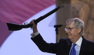 FILE - This March 6, 2014 file photo shows Senate Minority Leader Mitch McConnell of Ky. walks onto the stage holding a rifle before speaking at the Conservative Political Action Committee annual conference at National Harbor, Md. McConnell now has an endorsement to go with his gun. The National Rifle Association&#39;s political action committee announced Friday it has endorsed McConnell in the May 20 Republican primary. McConnell made headlines last month when he appeared at the Conservative Political Action Conference waving a rifle over his head. The rifle was a lifetime achievement award McConnell presented to Sen. Tom Coburn, R-Okla. (AP Photo/Susan Walsh, File)