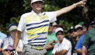 Bubba Watson points to his tee shot on the ninth hole during the second round of the Masters golf tournament Friday, April 11, 2014, in Augusta, Ga. (AP Photo/Darron Cummings) 