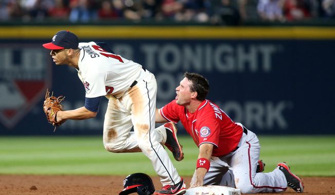 Washington Nationals&#x27; Ryan Zimmerman, right, reacts after being tagged out by Atlanta Braves shortstop Andrelton Simmons, left, at second base on a pickoff by Braves starting pitcher Alex Wood in the fifth inning of a baseball game on Saturday, April 12, 2014, in Atlanta. (AP Photo/Jason Getz)