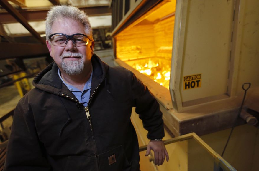 ADVANCE FOR SATURDAY APRIL 12 AND THEREAFTER - Mark Burnham, owner of Schaus-Vorhies Kleaning Inc. in Fairfield, Iowa, supplies waste heat from its sand fluidized bed, at right rear, to a neighboring greenhouse. The recycled waste heat may be the first use of it's kind in an Iowa greenhouse. (AP Photo/The Register, Christopher Gannon) MAGS OUT, TV OUT, NO SALES, MANDATORY CREDIT