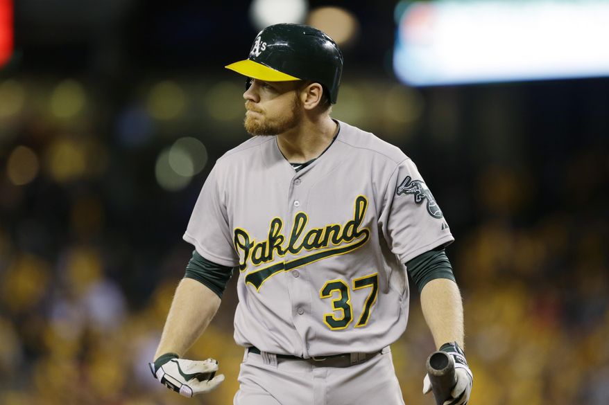 Oakland Athletics&#x27; Brandon Moss looks toward the mound after he struck out swinging against Seattle Mariners starting pitcher Felix Hernandez in the fourth inning of a baseball game, Friday, April 11, 2014, in Seattle. (AP Photo/Ted S. Warren)