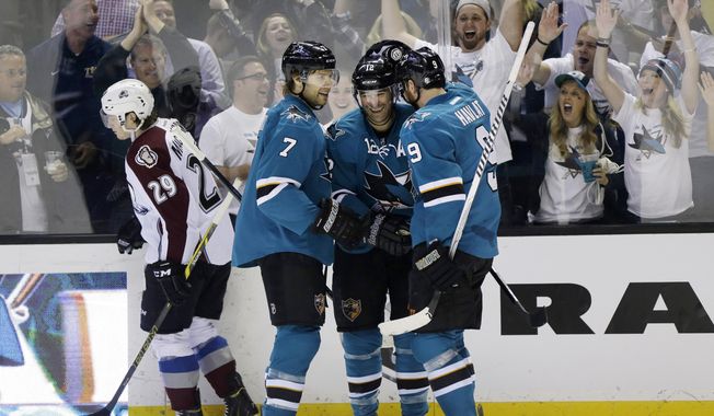 San Jose Sharks&#x27; Patrick Marleau, center, celebrates his goal with teammates Brad Stuart (7), and Martin Havlat (9), of the Czech Republic, during the first period of an NHL hockey game against the Colorado Avalanche on Friday, April 11, 2014, in San Jose, Calif. (AP Photo/Marcio Jose Sanchez)