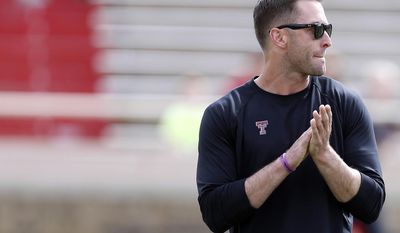 Texas Tech coach Kliff Kingsbury stands during a spring NCAA college football game Saturday, April 12, 2014, in Lubbock, Texas. (AP Photo/The Avalanche-Journal, Tori Eichberger)