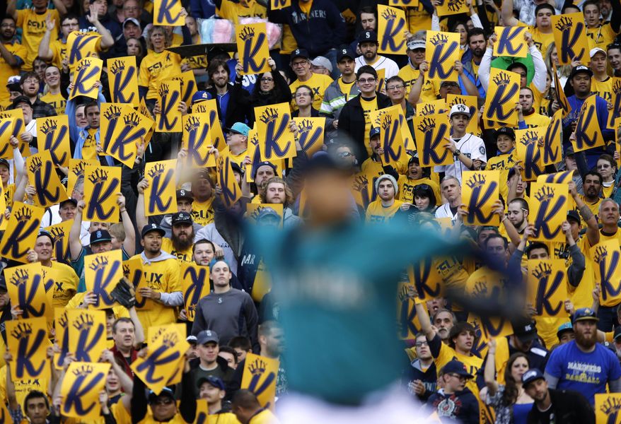 Fans hold up &amp;quot;K&amp;quot; strikeout cards as Seattle Mariners starting pitcher Felix Hernandez throws against the Oakland Athletics in the first inning of a baseball game, Friday, April 11, 2014, in Seattle. (AP Photo/Ted S. Warren)
