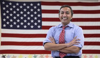 FILE - In this Oct. 26, 2012, file photo, Rep. Ami Bera is seen at his campaign office in Elk Grove, Calif., before winning his election that unseated incumbent Republican Dan Lungren. Bera, a first-term Democrat in a Sacramento-area seat, is a physician who favors expanding access to health care. Yet he has been voting with the Republican majority in the House to amend or overturn parts of the federal Affordable Care Act. Bera is one of a handful of Democrats in California who represent congressional districts that are closely divided between Democrats and Republicans, after voters approved an independent redistricting process. (AP Photo/Rich Pedroncelli, File)