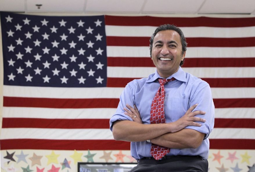 FILE - In this Oct. 26, 2012, file photo, Rep. Ami Bera is seen at his campaign office in Elk Grove, Calif., before winning his election that unseated incumbent Republican Dan Lungren. Bera, a first-term Democrat in a Sacramento-area seat, is a physician who favors expanding access to health care. Yet he has been voting with the Republican majority in the House to amend or overturn parts of the federal Affordable Care Act. Bera is one of a handful of Democrats in California who represent congressional districts that are closely divided between Democrats and Republicans, after voters approved an independent redistricting process. (AP Photo/Rich Pedroncelli, File)