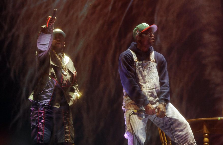 Big Boi, left, and Andre 3000 of Outkast perform behind a screen during their headlining set on the first day of the 2014 Coachella Music and Arts Festival on Friday, April 11, 2014, in Indio, Calif. (Photo by Chris Pizzello/Invision/AP)