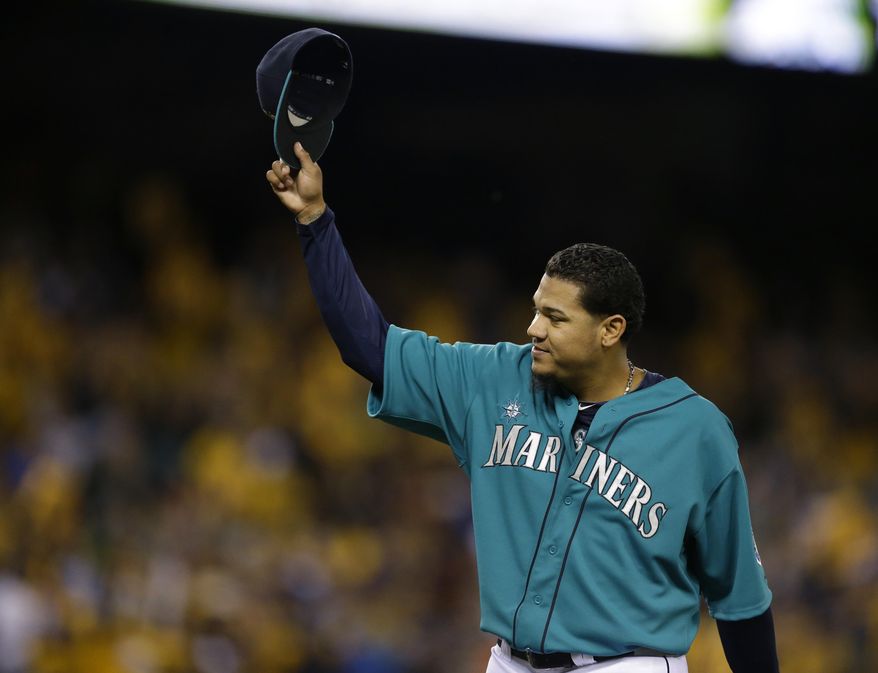 Seattle Mariners starting pitcher Felix Hernandez tips his cap to fans as he leaves a baseball game against the Oakland Athletics in the eighth inning, Friday, April 11, 2014, in Seattle. Hernandez struck out 11 batters and allowed no runs. (AP Photo/Ted S. Warren)
