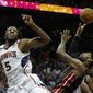 Miami Heat forward LeBron James, front right, is fouled under the basket by Atlanta Hawks forward DeMarre Carroll (5) during the first half of an NBA basketball game on Saturday, April 12, 2014, in Atlanta. (AP Photo/John Amis)
