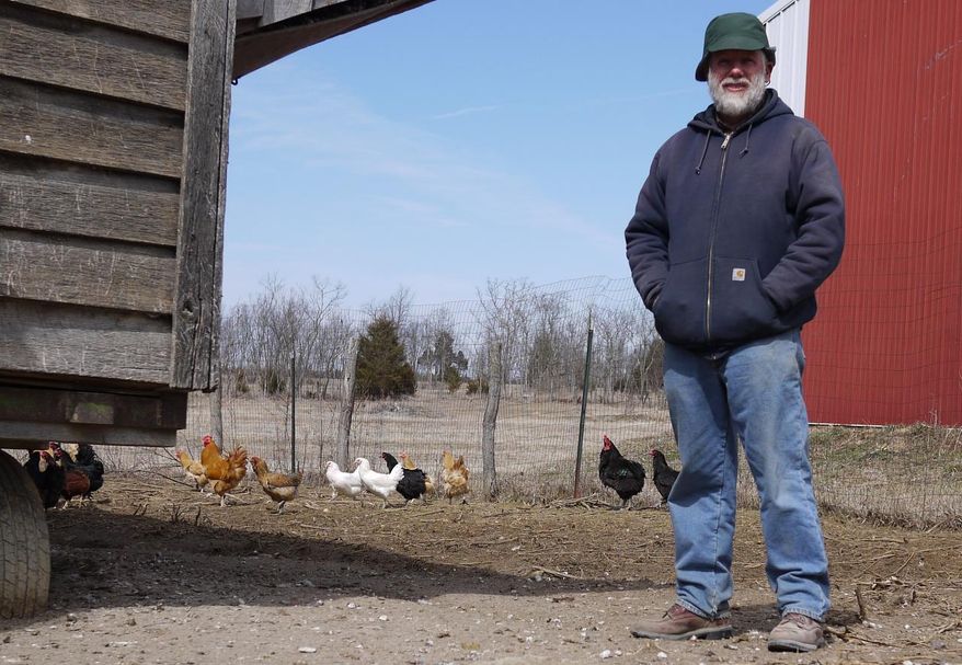 ADVANCE FOR SUNDAY APRIL 13 AND THEREAFTER- In this Tuesday March 25, 2014 photo, farmer Bill Grantham poses for a photo at his farm in Kearneyville, W.Va. Grantham said demand is high locally for eggs raised on non-genetically modified corn. He charges $5 for a dozen eggs at area farmers’ markets and routinely sells out. (AP Photo/Spirit of Jefferson and Farmer's Advocate, Randy Snyder)