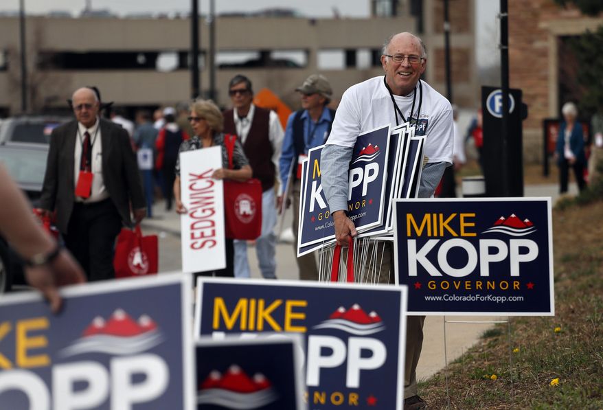 Campaign workers for candidate for Colorado governor Mike Kopp collect signs following the state GOP Congress,  in Boulder, Colo., Saturday, April 12, 2014. Kopp and Colorado Secretary of State Scott Gessler made the ballot in hope of challenging Democratic Gov. John Hickenlooper this fall. (AP Photo/Brennan Linsley)