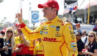 Ryan Hunter-Reay gestures after winning the pole position at IndyCar qualifying for the Grand Prix of Long Beach auto race on Saturday, April 12, 2014, in Long Beach, Calif. (AP Photo/Alex Gallardo)