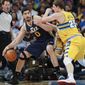 Utah Jazz center Enes Kanter, left, of Turkey, works ball inside as Denver Nuggets center Timofey Mozgov, of Russia, covers in the first quarter of an NBA basketball game in Denver on Saturday, April 12, 2014. (AP Photo/David Zalubowski)