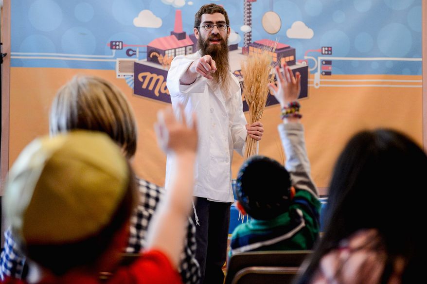 Rabbi Levi Raskin, with JCrafts, teaches children how to make matzah bread at Congregation Har Tzeon-Agudath Achim in Silver Spring. (photographs by Andrew Harnik/The Washington Times)