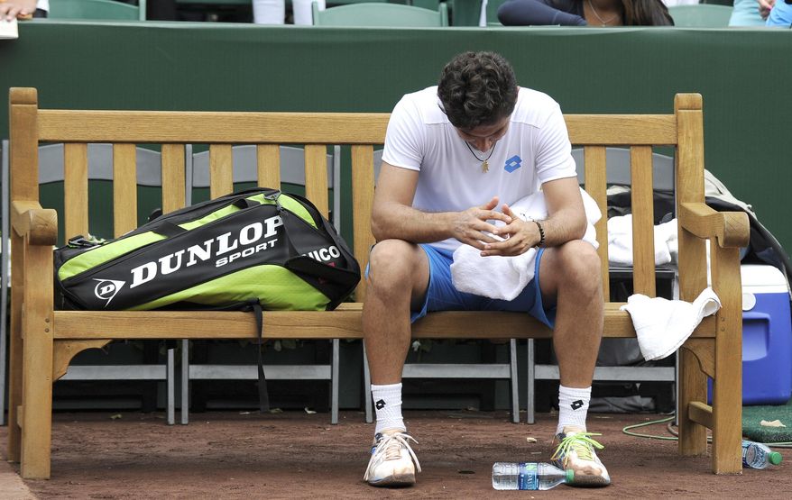 Spain's Nicolas Almagro sits on the bench after losing to countryman Fernando Verdasco in the final at the U.S. Men's Clay Court Championship tennis tournament Sunday, April 13, 2014, in Houston. Verdasco won 6-3, 7-6 (4). (AP Photo/Pat Sullivan)