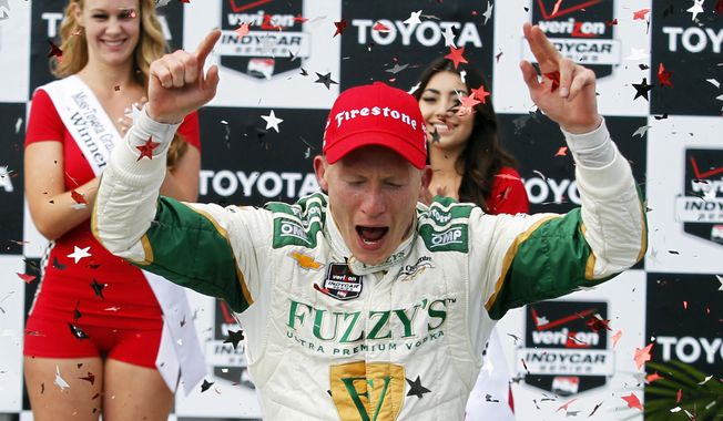 Mike Conway, of England, celebrates his win in the IndyCar Grand Prix of Long Beach auto race, Sunday, April 13, 2014, in Long Beach, Calif. (AP Photo/Alex Gallardo)