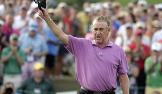 Miguel Angel Jimenez, of Spain, holds up his visor on the 18th hole following his fourth round of the Masters golf tournament Sunday, April 13, 2014, in Augusta, Ga. (AP Photo/Chris Carlson)