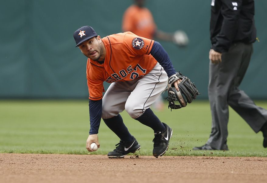 Houston Astros second baseman Jose Altuve picks up the grounder by Texas Rangers' Shin-Soo Choo during the first inning of a baseball game, Sunday, April 13, 2014, in Arlington, Texas. Shin-Soo Choo was called safe, but was ruled out after a challenge. (AP Photo/Jim Cowsert)