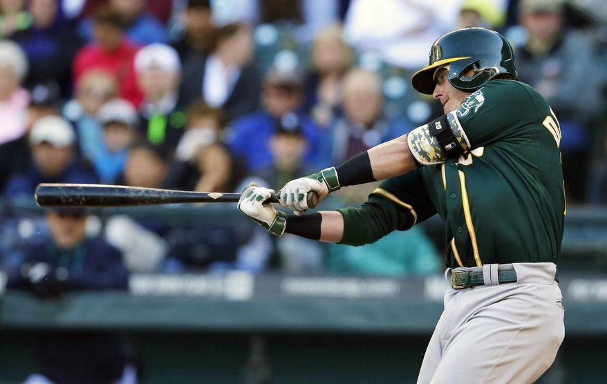 Oakland Athletics&#x27; Josh Donaldson hits a two-run home run in the first inning of a baseball game against the Seattle Mariners, Saturday, April 12, 2014, in Seattle. (AP Photo/Ted S. Warren)