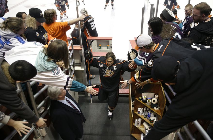 Anaheim Ducks' Teemu Selanne, center, of Finland, is greeted by the fans during practice for an NHL hockey game against the Colorado Avalanche on Sunday, April 13, 2014, in Anaheim, Calif. Selanne plays his final regular-season game Sunday night. (AP Photo/Jae C. Hong)