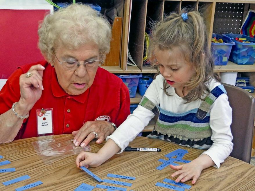 ADVANCE FOR USE MONDAY, APRIL 14, 2014, AND THEREAFTER- In this undated photo Joyce Barkoff helps Bailey Bowers with an assignment at Cave City Elementary, in Cave City, Ark. Barkoff has been a foster grandparent at the Cave City School District since 2009. (AP Photo/Batesville Daily Guard, Luke Stroud)