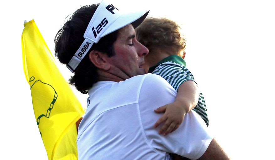 Bubba Watson carries his son Caleb after winning the Masters golf tournament Sunday, April 13, 2014, in Augusta, Ga. (AP Photo/Matt Slocum) 