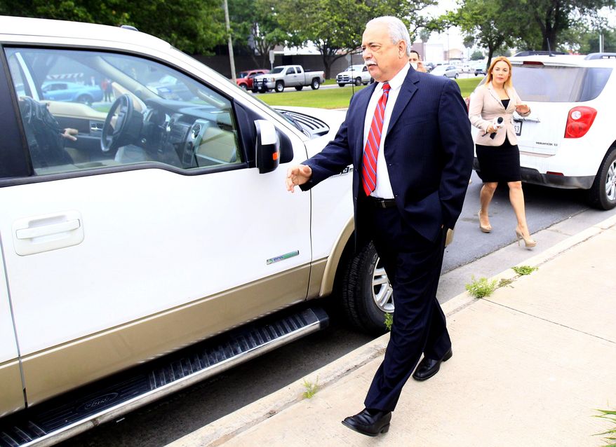 Former Hidalgo County Sheriff Lupe Trevino leaves the McAllen Federal Court building with his attorney Robert Yzaguirre, Monday, April 14, 2014, in McAllen, Texas. Trevino pleaded guilty Monday to money laundering and faces a 20-year sentence. He was released on a $30,000 unsecured bond Monday. (AP Photo/The Monitor, Gabe Hernandez)