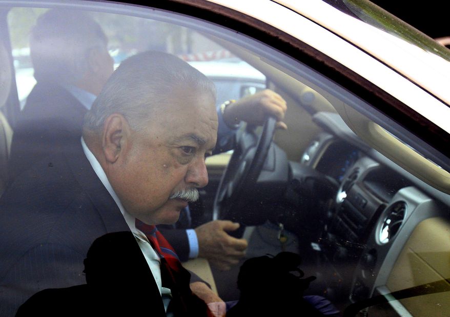 Former Hidalgo County Sheriff Lupe Trevino leaves the McAllen Federal Court building with his attorney Robert Yzaguirre, Monday, April 14, 2014, in McAllen, Texas. Trevino pleaded guilty Monday to money laundering and faces a 20-year sentence. He was released on a $30,000 unsecured bond Monday. (AP Photo/The Monitor, Gabe Hernandez)